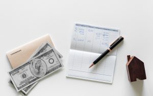 checkbook with ledger and cash for expenses